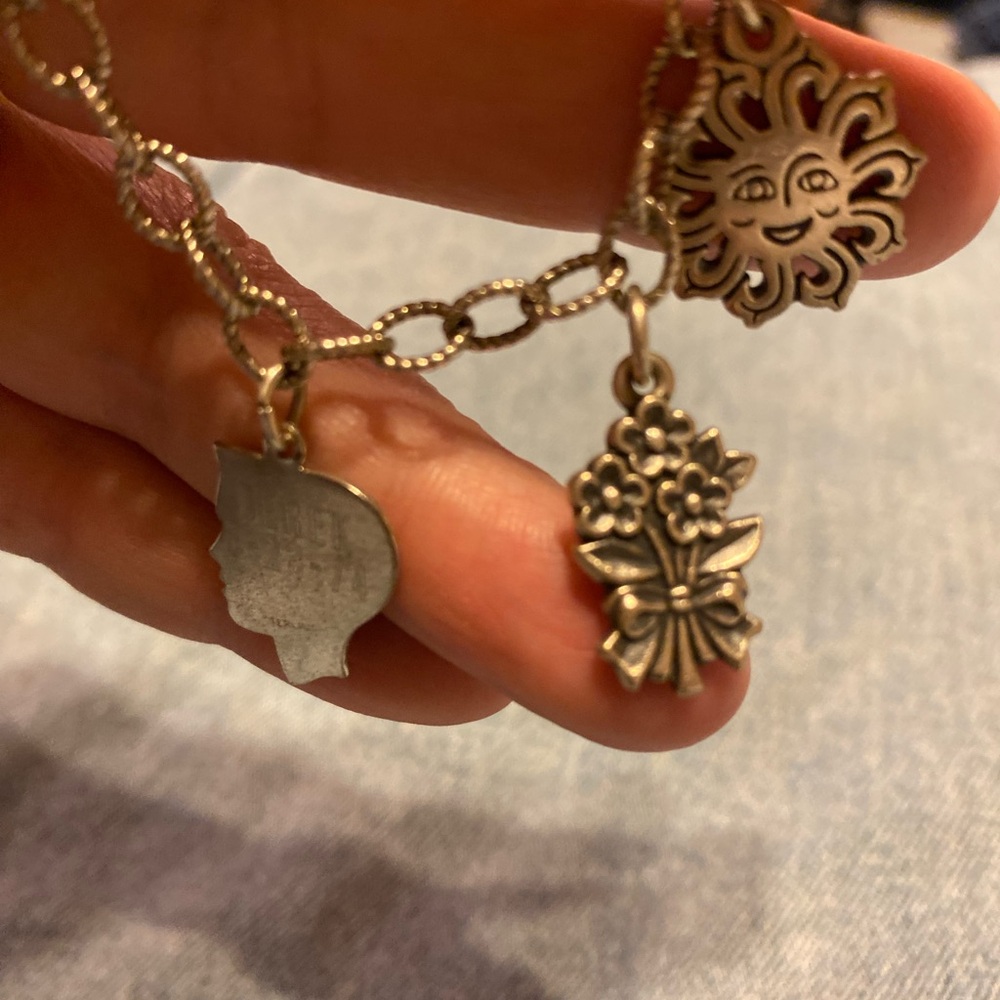 James avery sun, flowers and bracelet are James Avery. Boy is not James Avery